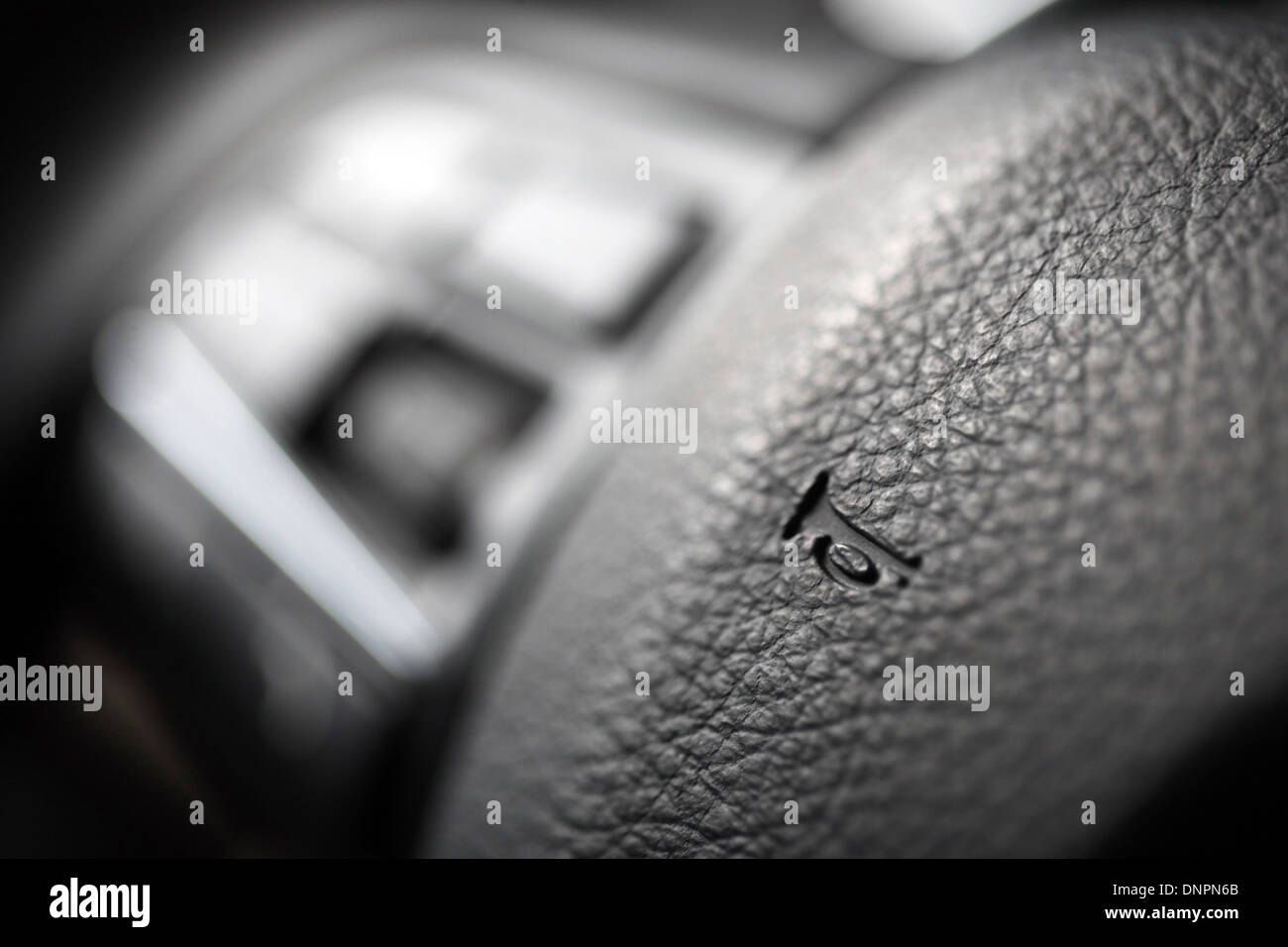 Close up shot of the horn button on a car's steering wheel Stock Photo