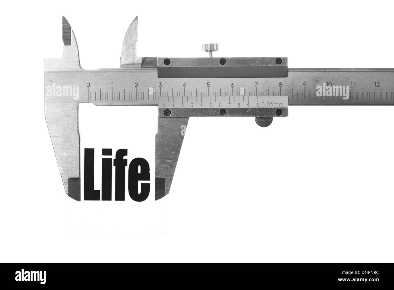 Picture of a caliper, measuring the word 'Life'. Stock Photo