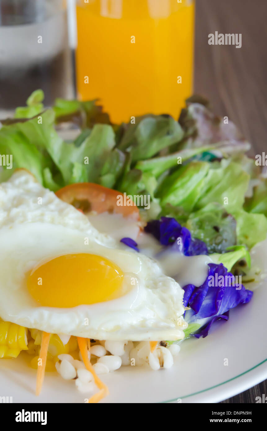 fried egg and fresh salad on dish Stock Photo