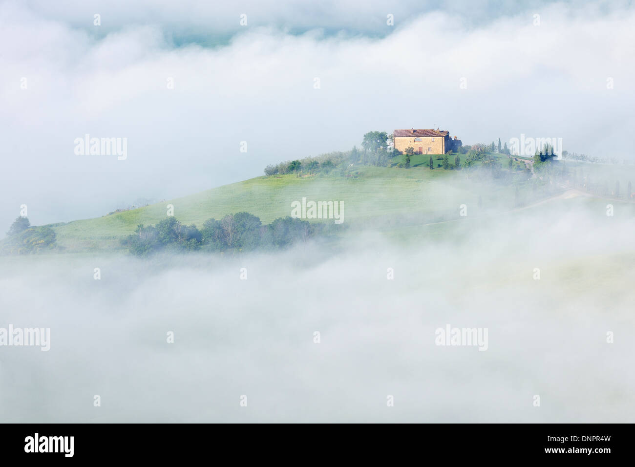 Typical Tuscany landscape with farm in morning with fog near Pienza. Pienza, Siena district, Tuscany, Toscana, Italy. Stock Photo