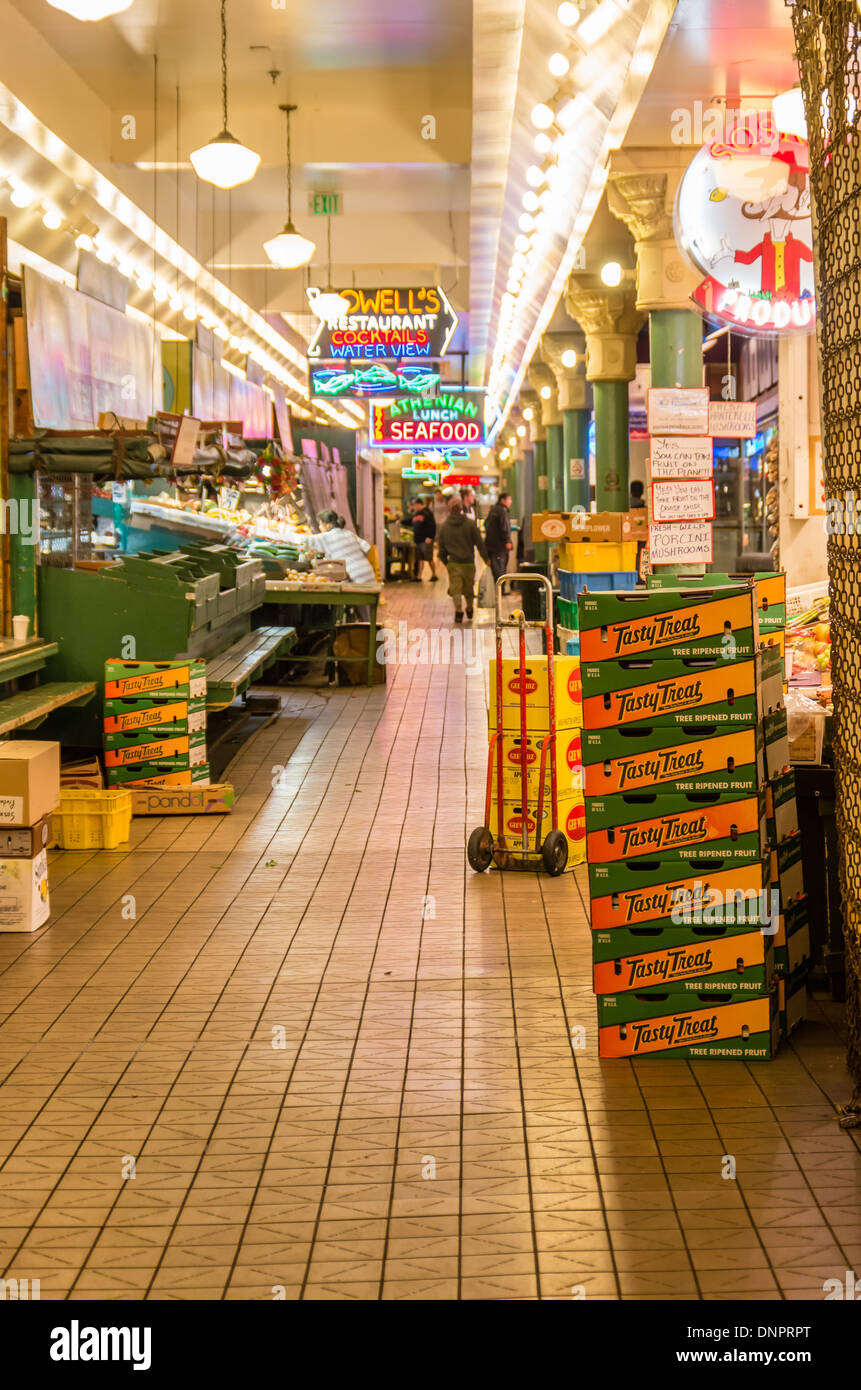 Vendors preparing to open produce stalls in early morning Pike Place Market Seattle, Washington, USA Stock Photo