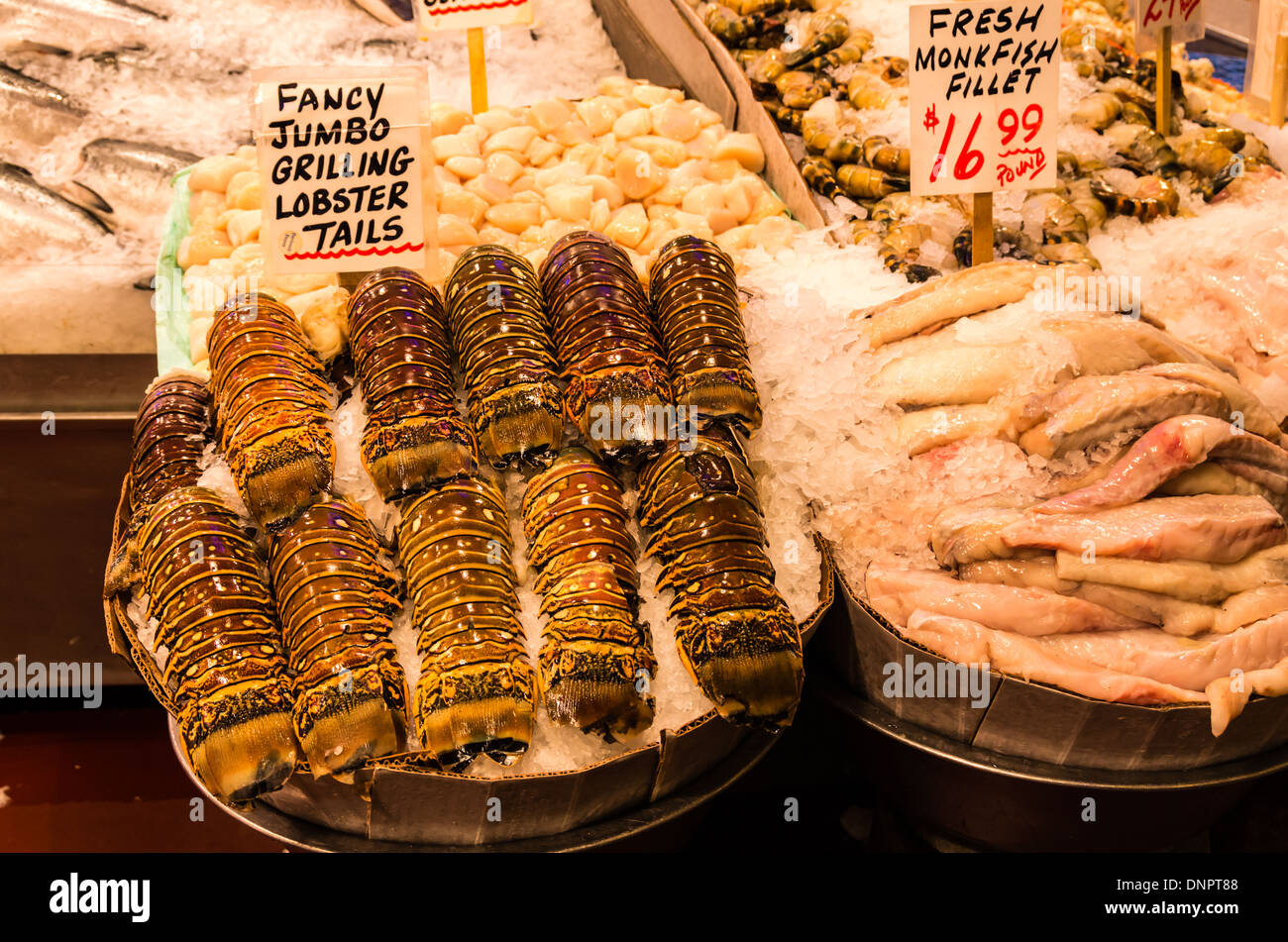 Lobster tails on ice with seafood in fish monger's stall Pike Place Market Seattle ,Washington, USA Stock Photo