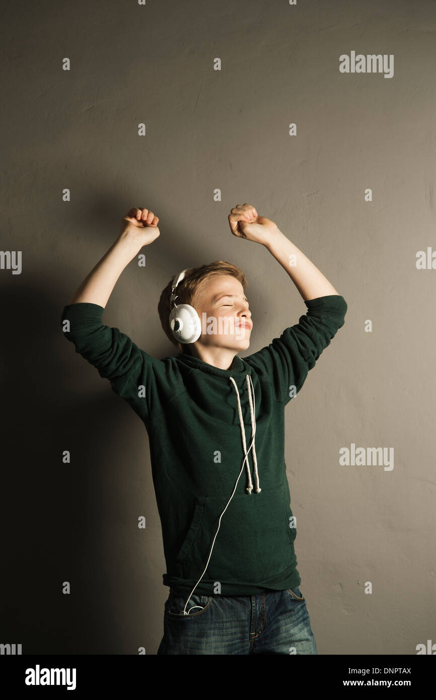 Boy Listening to Music with Headphones, Studio Shot Stock Photo