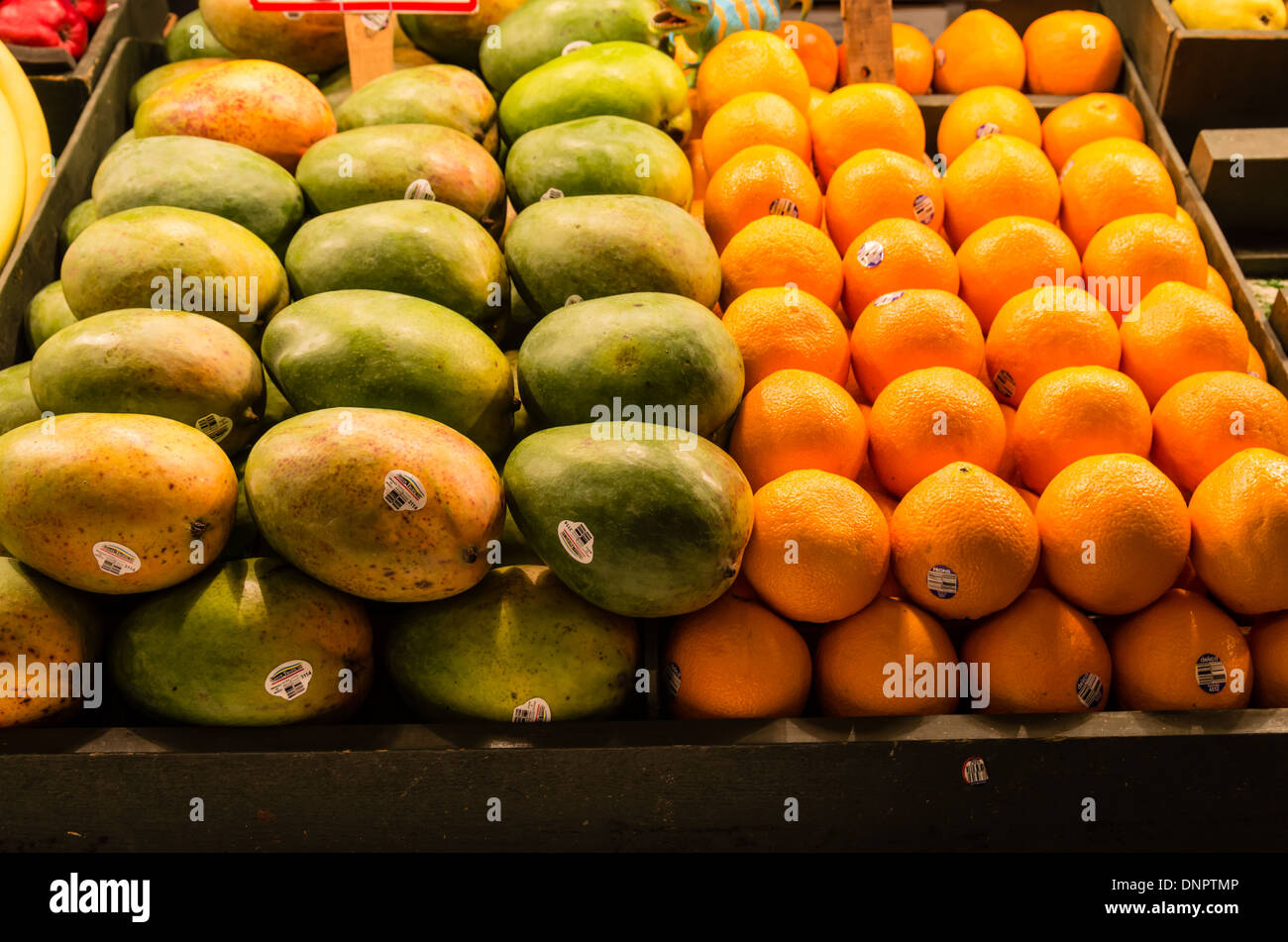 Fresh fruit papaya and oranges on display in a produce vendors stall Pike Place Market Seattle, Washington, USA Stock Photo
