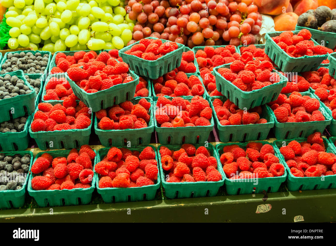 Red raspberries in small boxes on display at a market stall Pike Place Market Seattle, Washington, USA Stock Photo
