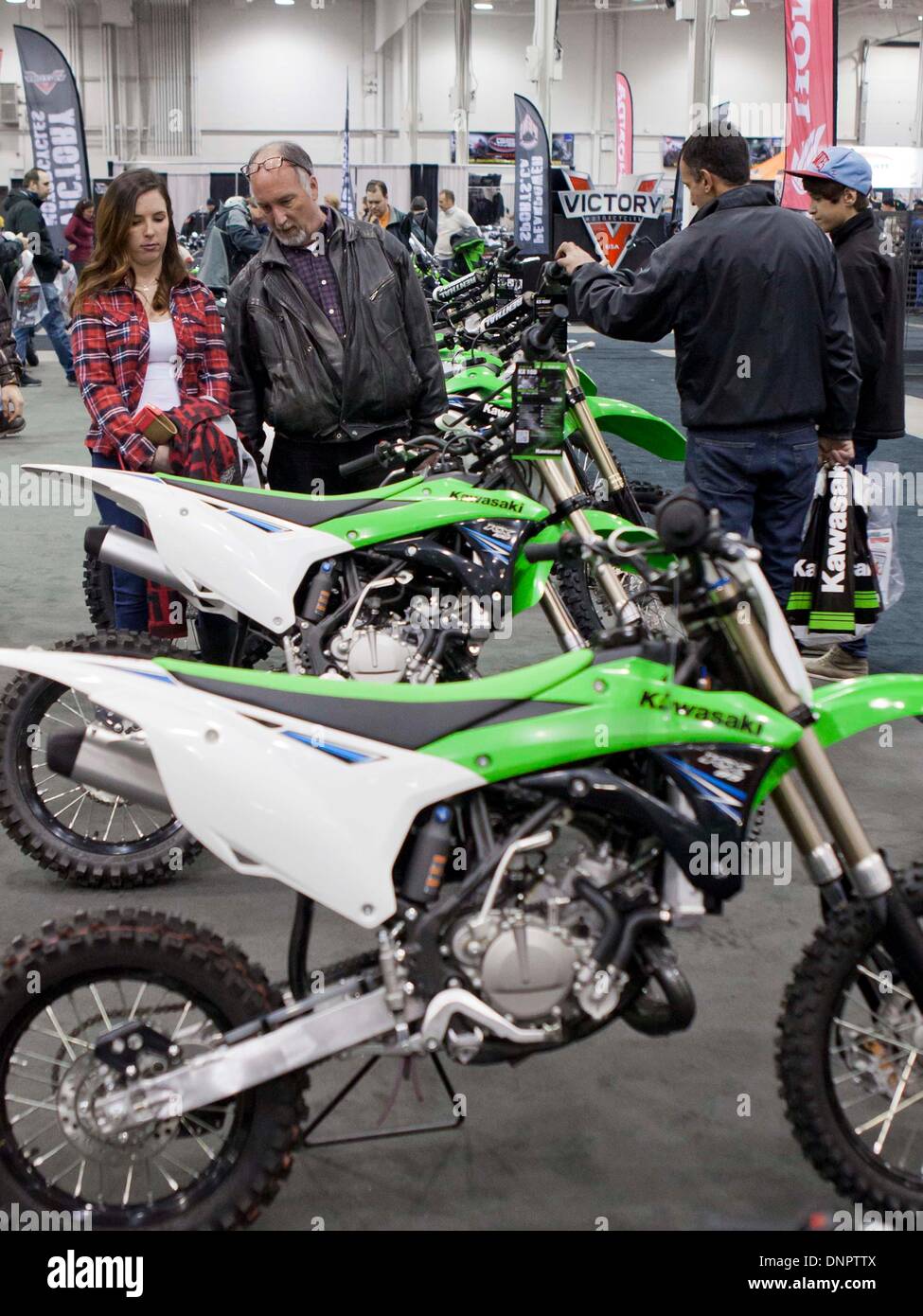 Toronto, Canada. 3rd Jan, 2014. Visitors look at motorcycles during the