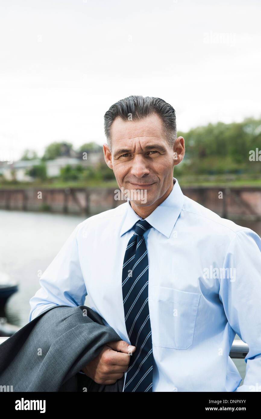 Portrait of mature businessman outdoors, smiling at camera, Mannheim, Germany Stock Photo