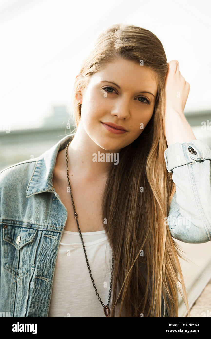 Portrait of young woman outdoors, looking at camera Stock Photo