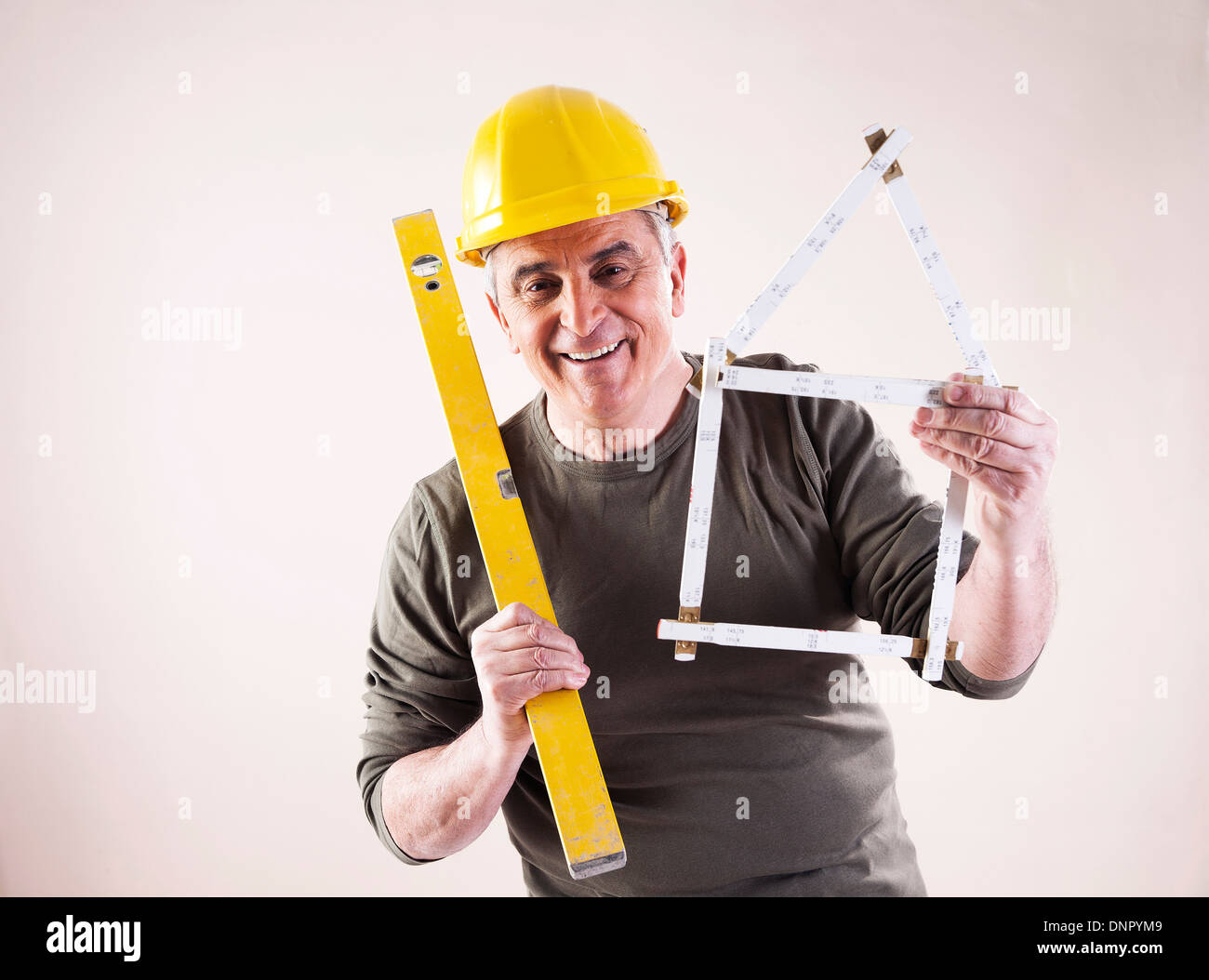 Portrait of Contractor with Level and Ruler, Studio Shot Stock Photo ...