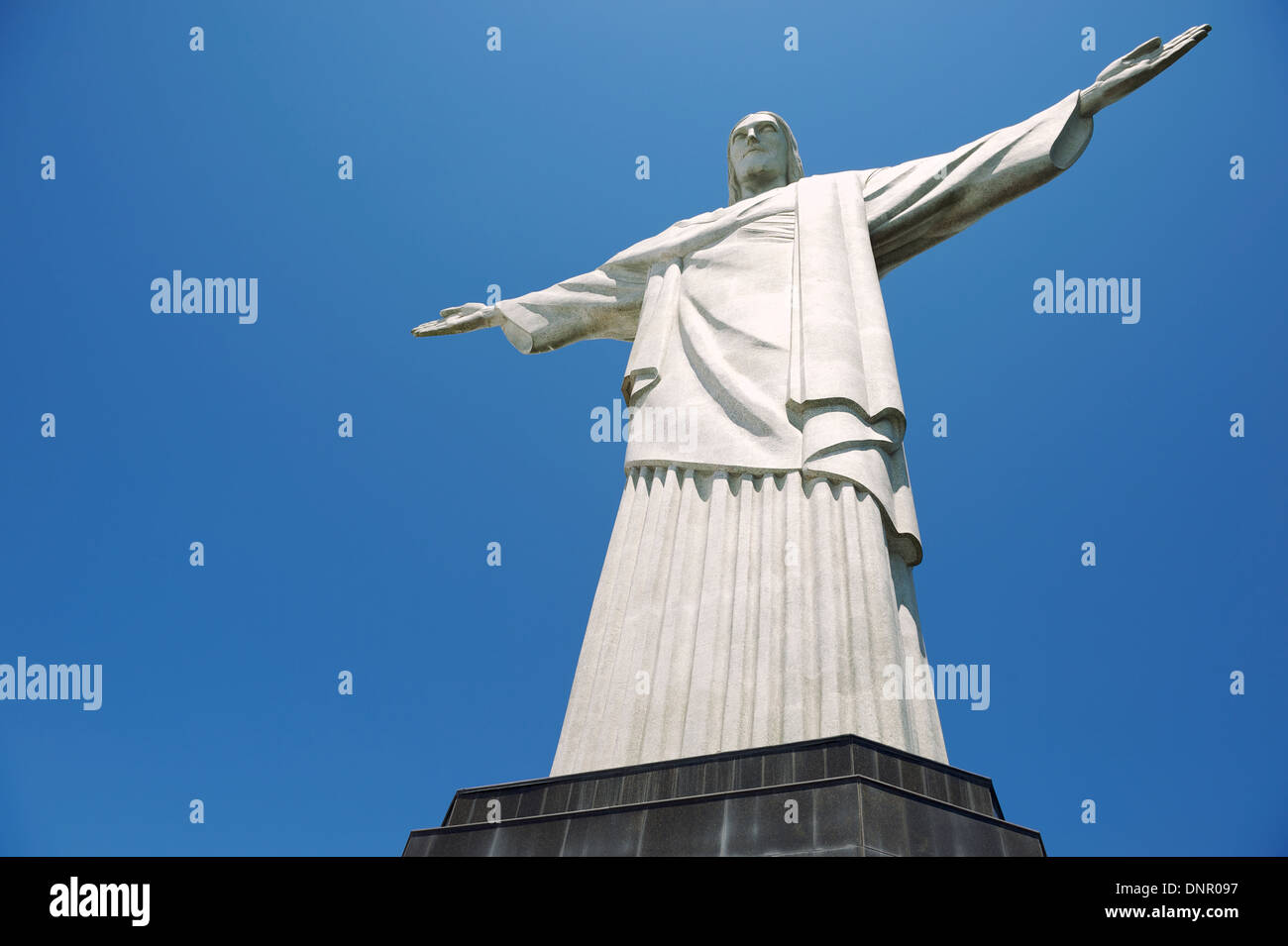 Corcovado Christ the Redeemer statue stands full length on pedestal in blue sky Rio de Janeiro Brazil Stock Photo