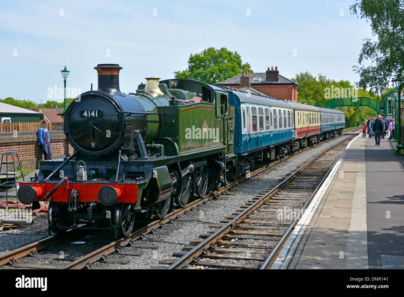 Steam tank engine locomotive 4141 & passenger train at platform on Epping and Ongar preserved heritage railway at North Weald station Essex England UK Stock Photo