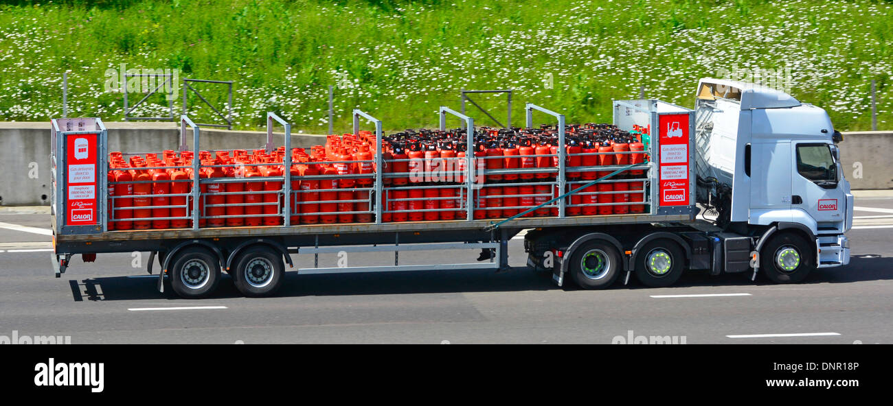 Calor Gas hgv lorry truck and articulated trailer fully loaded with Propane Gas Bottles driving along M25 motorway road Essex England UK Stock Photo