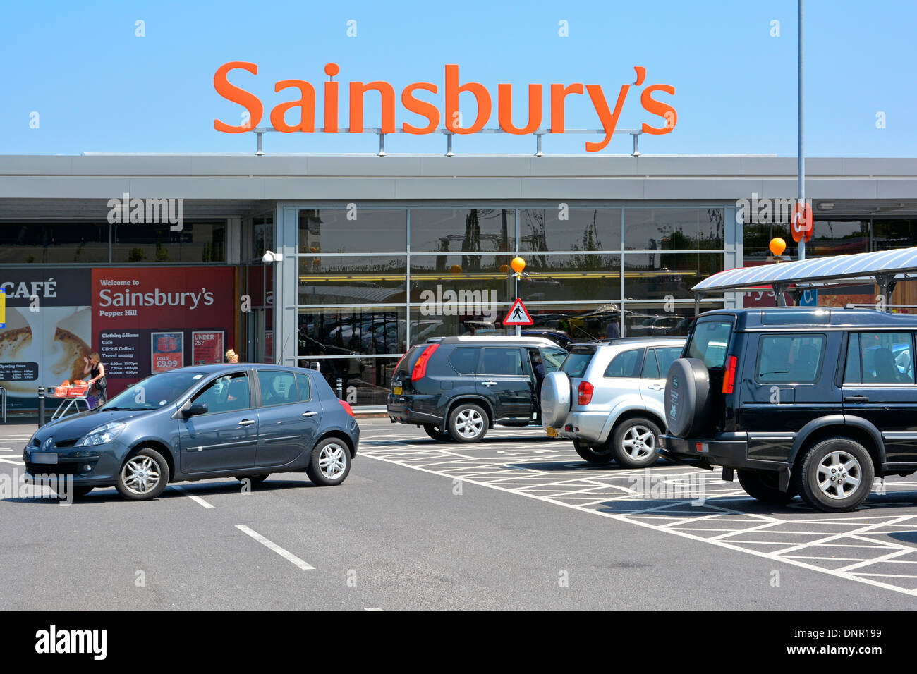 Sainsbury's supermarket store sign, entrance and car park Stock Photo