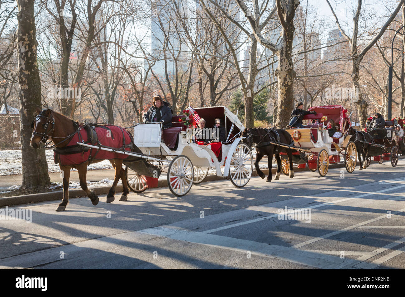 Horse drawn carriages and snow in new york city hi-res stock ...