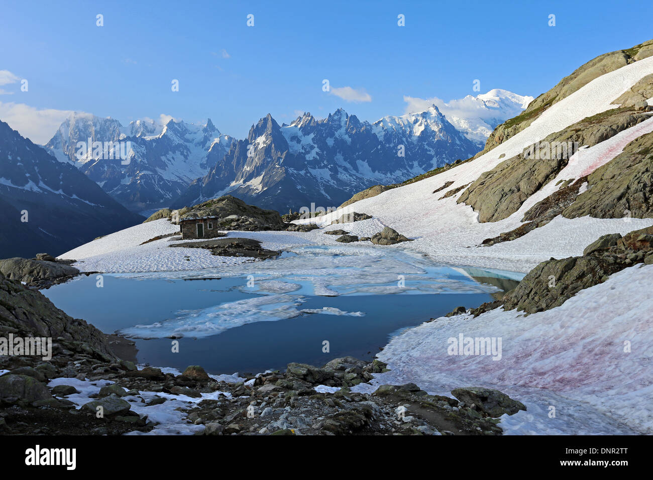 Lac Blanc and peaks of the Mont Blanc mountain group. Alpine landscape with lake and snow. Aiguilles Rouges massif, French Alps. Europe. Stock Photo