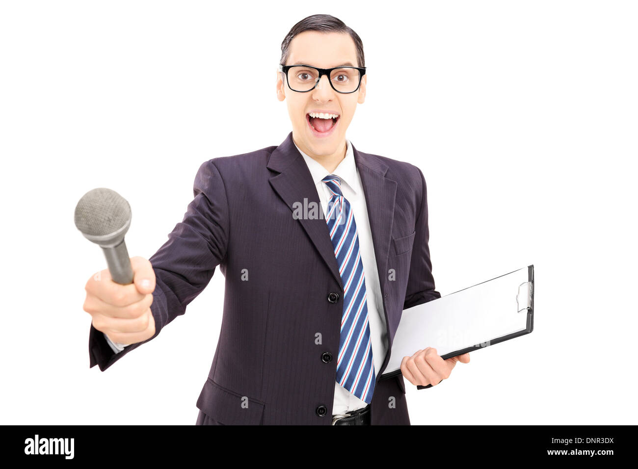 Excited young male interviewer in suit holding microphone Stock Photo