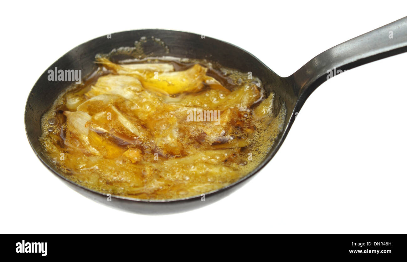 Garlic in hot Mustard oil Indian herbal treatment Stock Photo Alamy