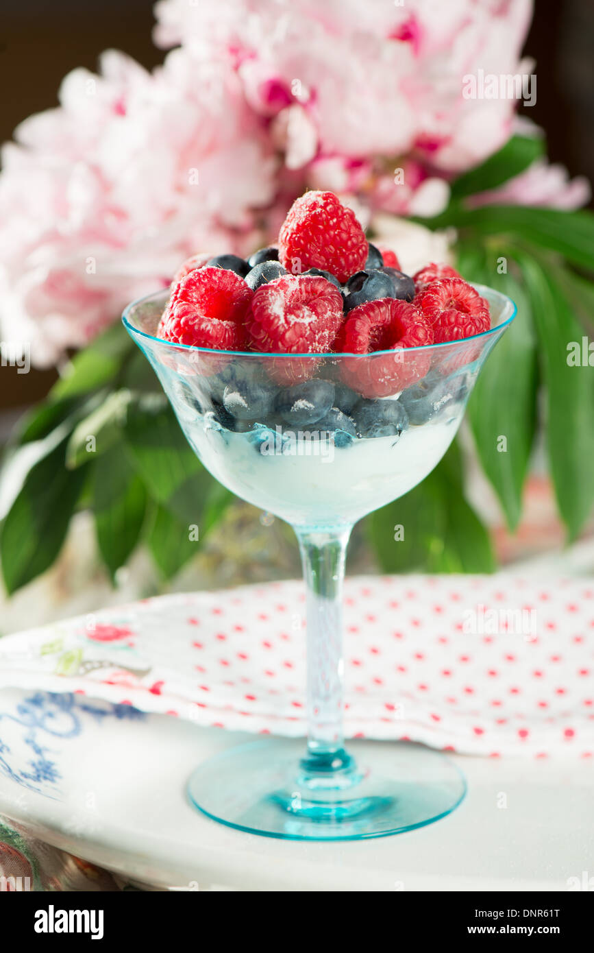 Berry and yogurt Parfait in aqua champagne glass Stock Photo