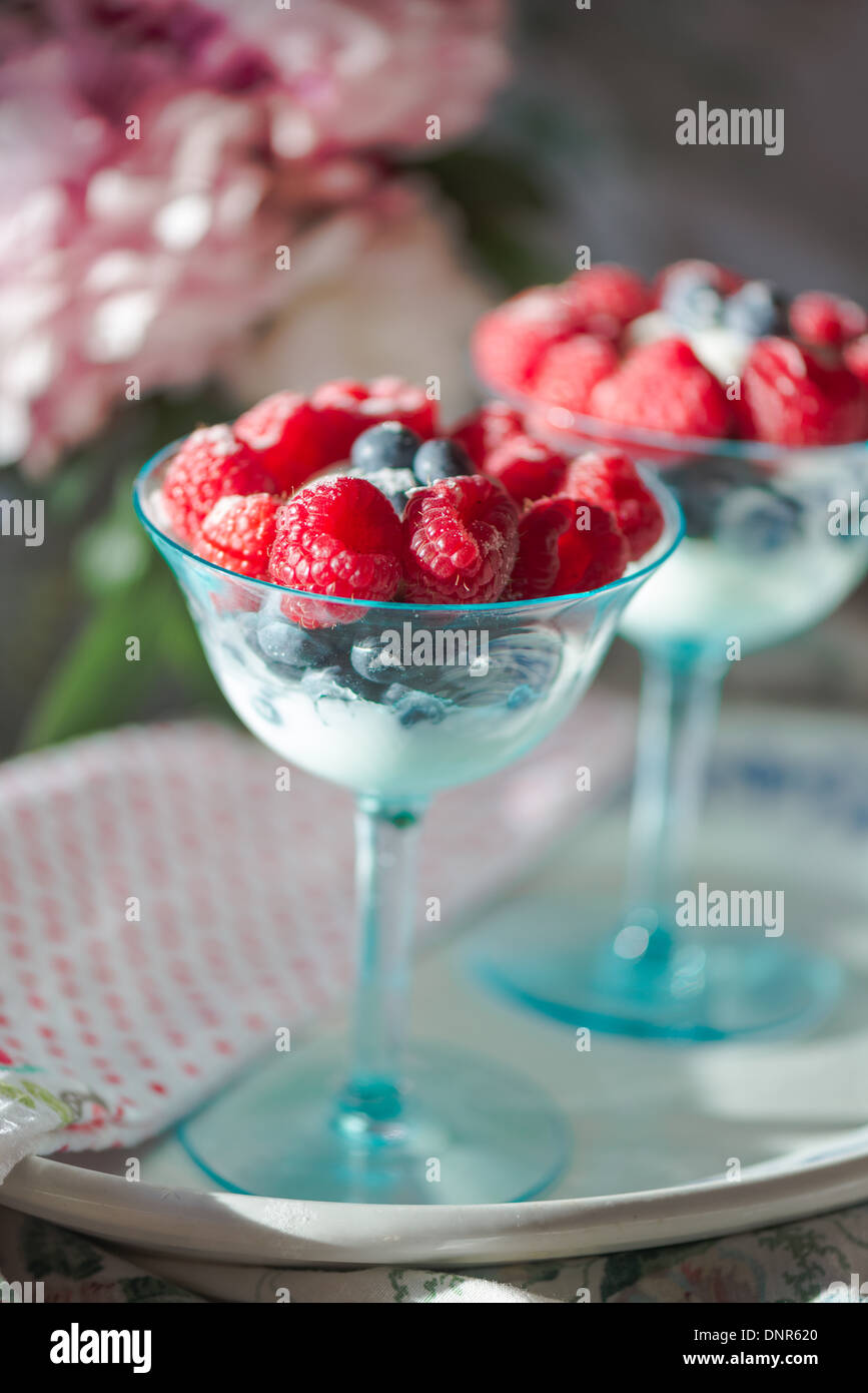 Blueberry and raspberry parfait in aqua champagne glasses Stock Photo
