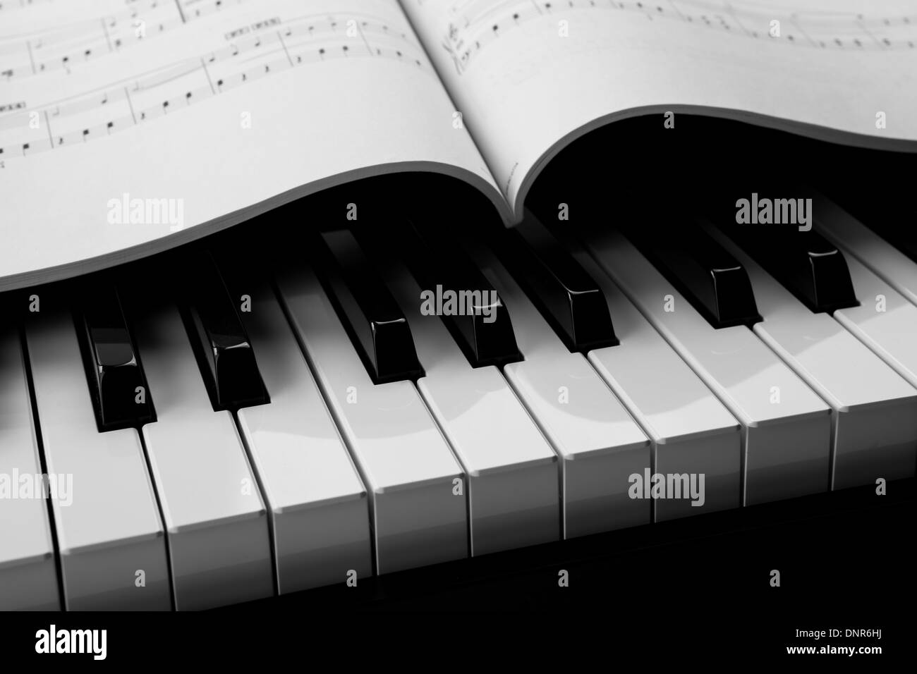 black and white keys of the piano closeup and musical book Stock Photo