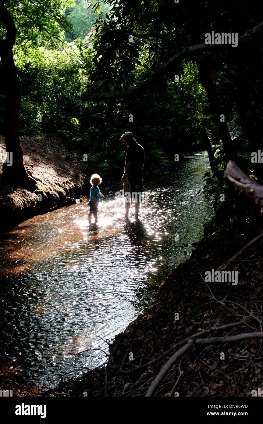 father and son in stream Stock Photo