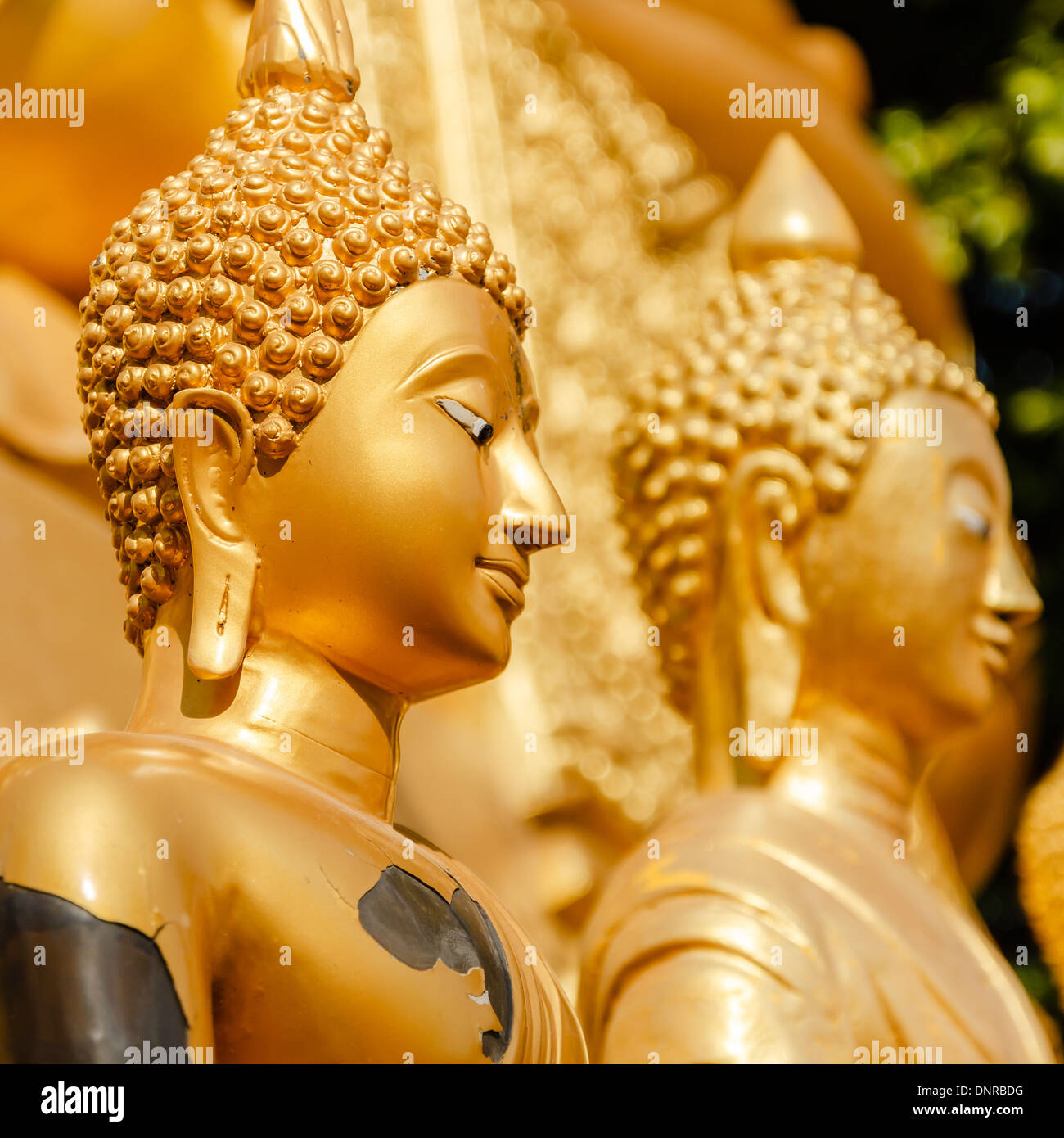 Gold statue of Buddha in Mae Sot, Thailand Stock Photo