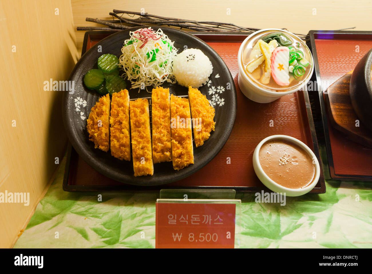 Plastic food model (tonkatsu - breaded pork cutlet) display case at fast food restaurant - Seoul, South Korea Stock Photo