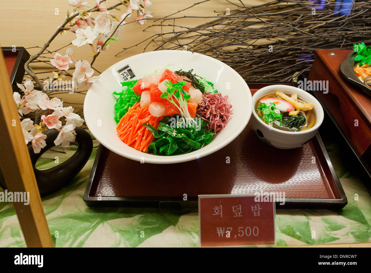 Plastic food model (sashimi over rice) display case at fast food restaurant - Seoul, South Korea Stock Photo