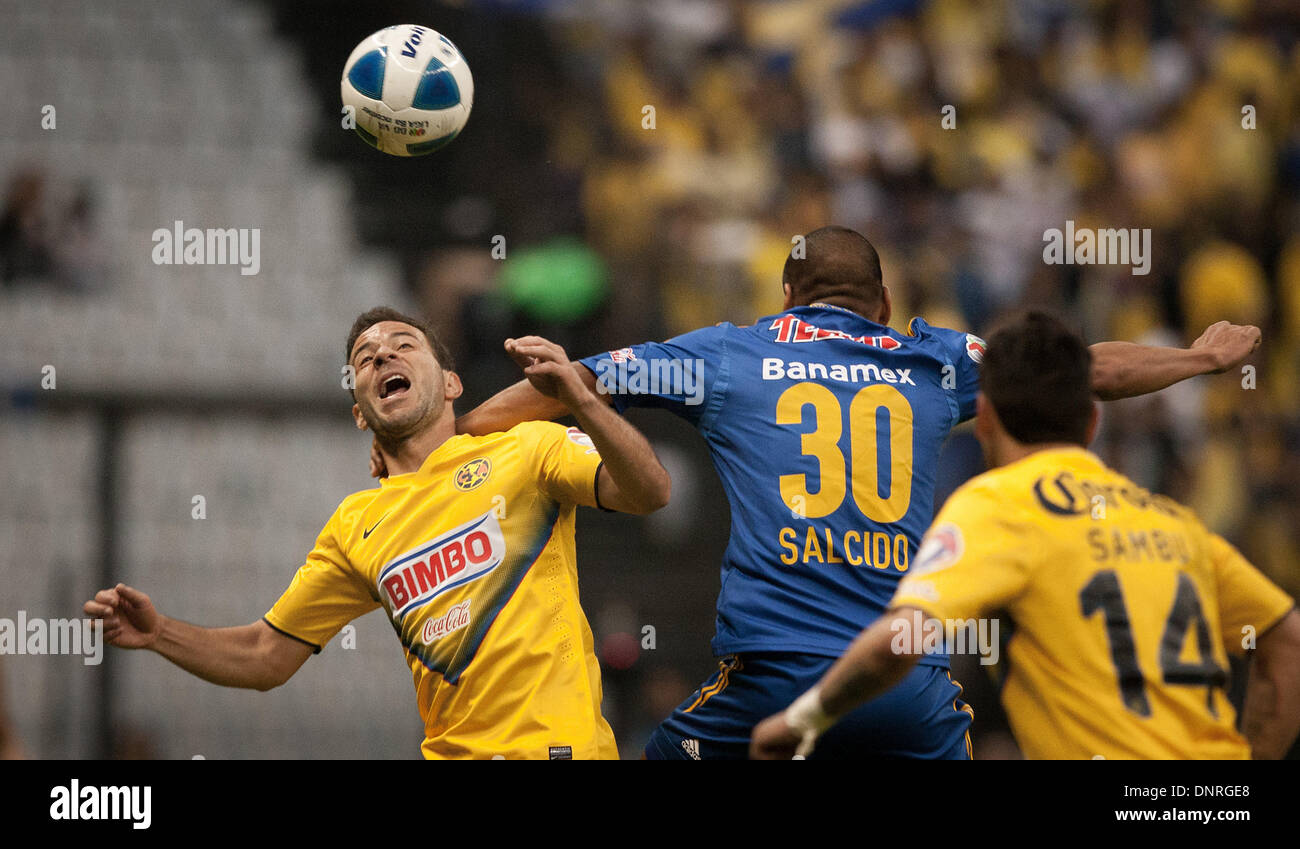 Mexico City, Mexico. 4th Jan, 2014. Luis Gabriel Rey (L) of America vies for the ball with Carlos Salcido (C) of Tigres during their match of the MX League Closing Tournament 2014, held in the Azteca Stadium, in Mexico City, capital of Mexico, on Jan. 4, 2014. Credit:  Pedro Mera/Xinhua/Alamy Live News Stock Photo