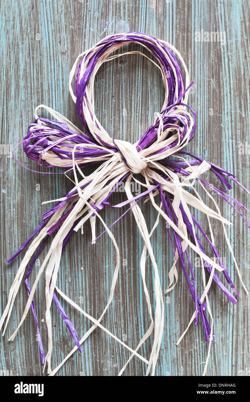 Purple straw decoration on a wodden surface Stock Photo