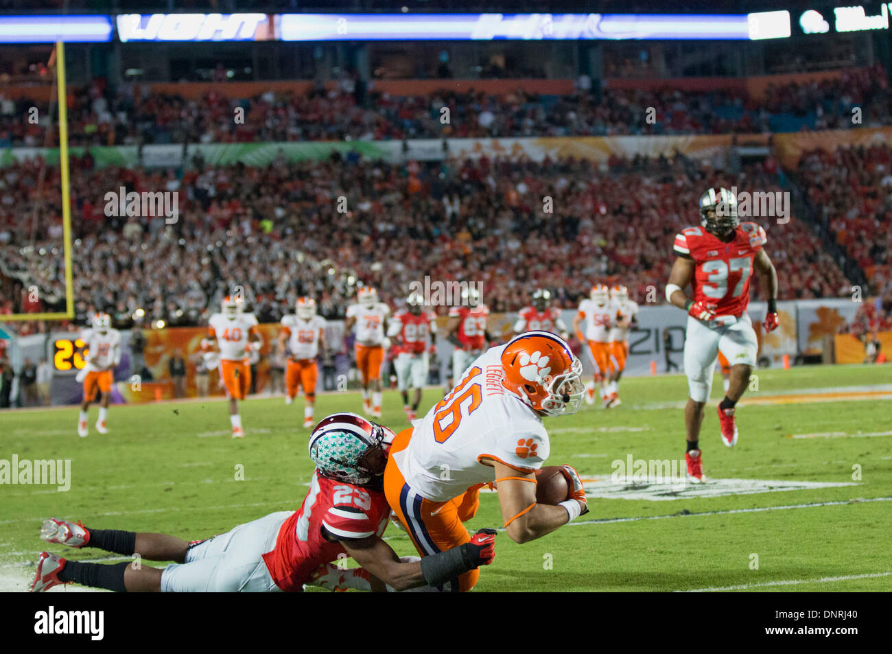 Miami Gardens, FL, USA. 3rd Jan, 2014. Clemson Tigers tight end Jordan Leggett (16) is tackled by Ohio State Buckeyes defensive back Tyvis Powell (23) after a long reception during the Discover Orange Bowl between the Clemson Tigers and the Ohio State Buckeyes at Sun Life Stadium. Clemson beat Ohio State 40-35. Credit:  csm/Alamy Live News Stock Photo