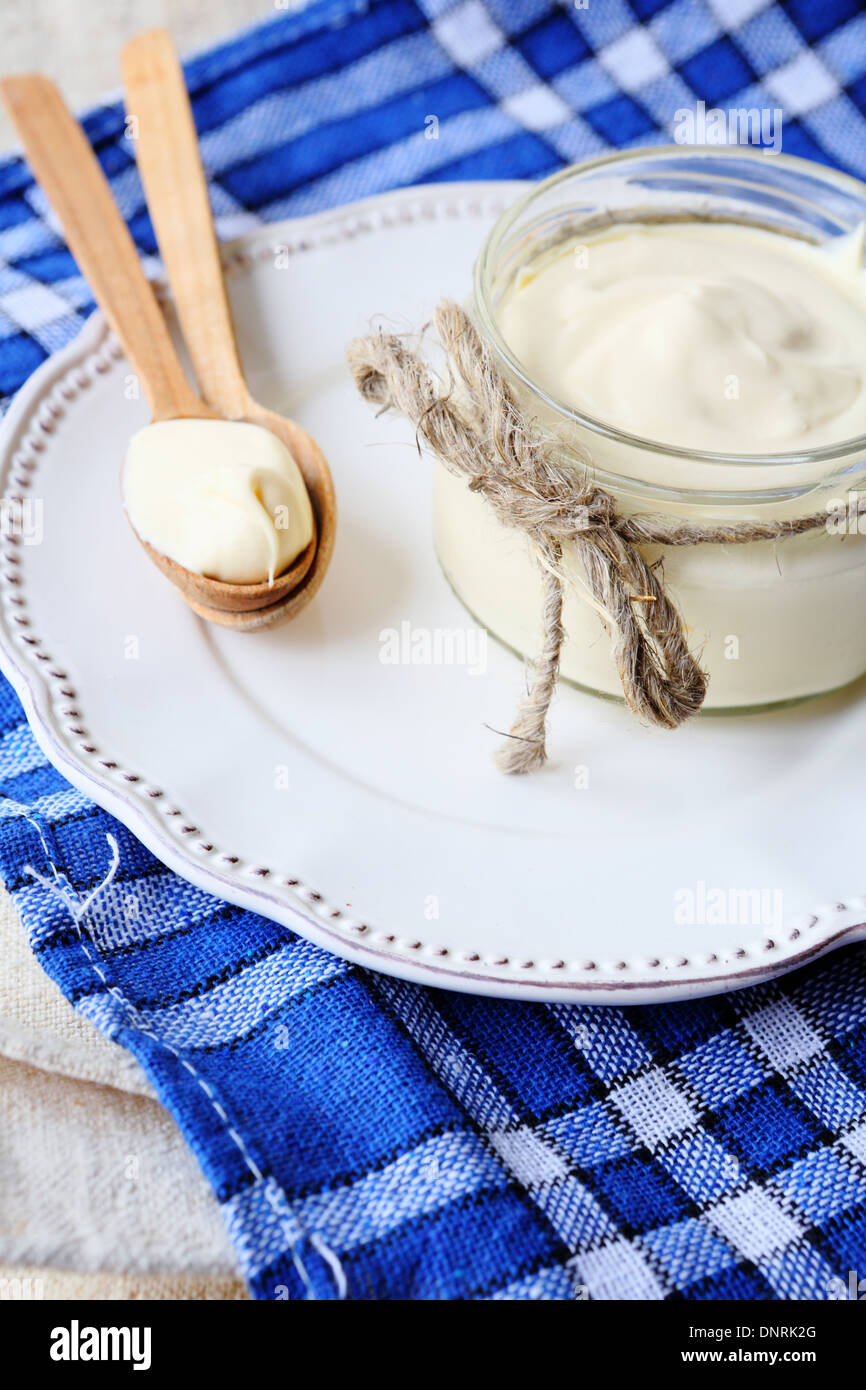 fresh sour cream in a jar, food closeup Stock Photo