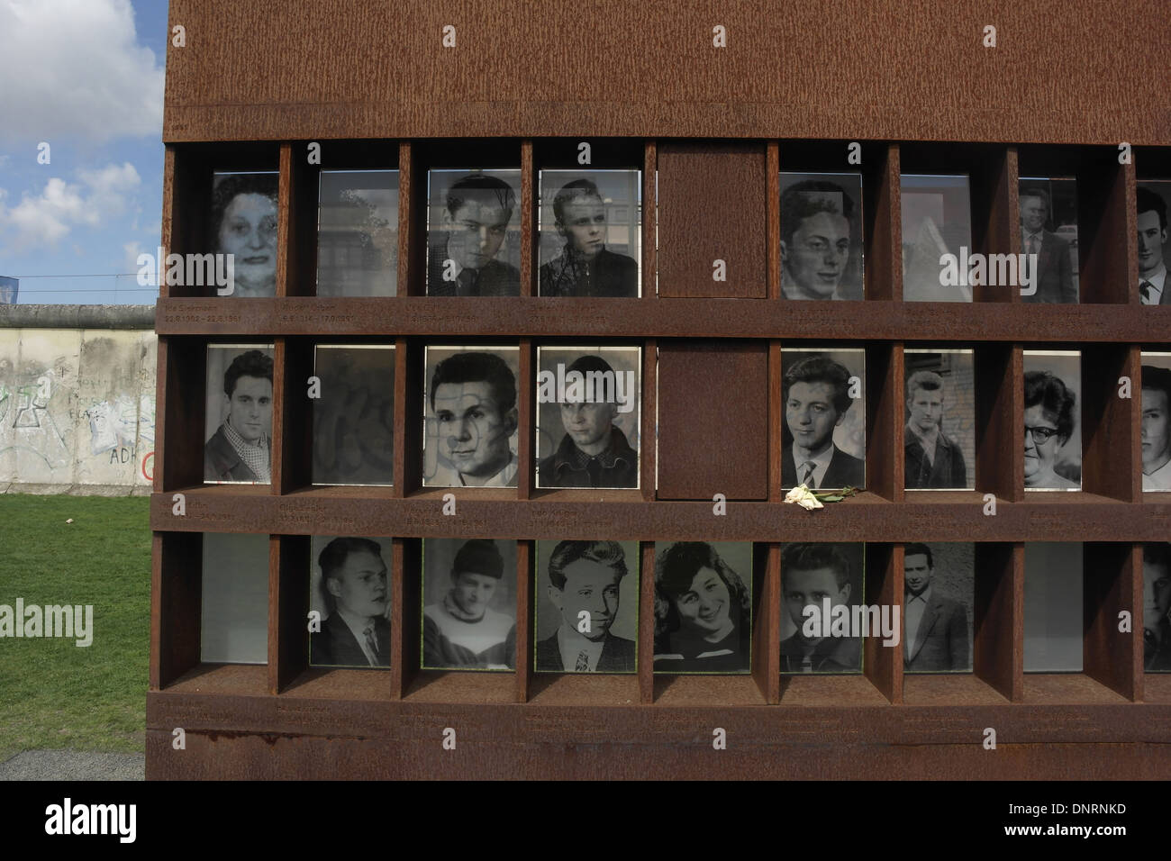 Blue sky view three rows monochrome photographs 22 Berlin Wall victims