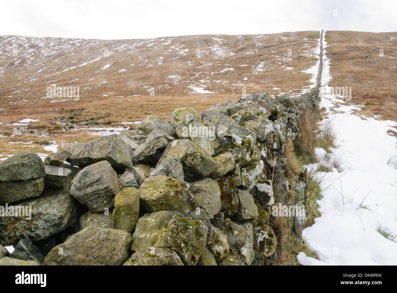 Drystone wall in the Mourne Mountains with snow in the winter. Stock Photo