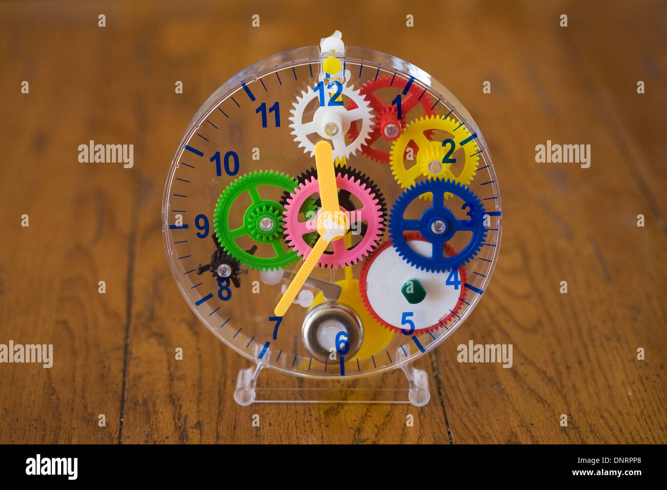 Child's teaching clock on a wooden table. Stock Photo