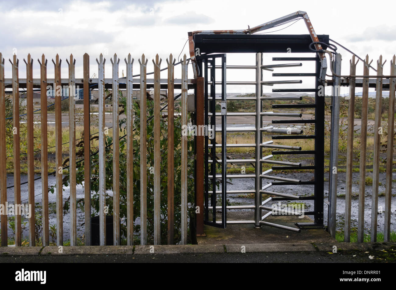 Security turnstile at an abandoned factory Stock Photo