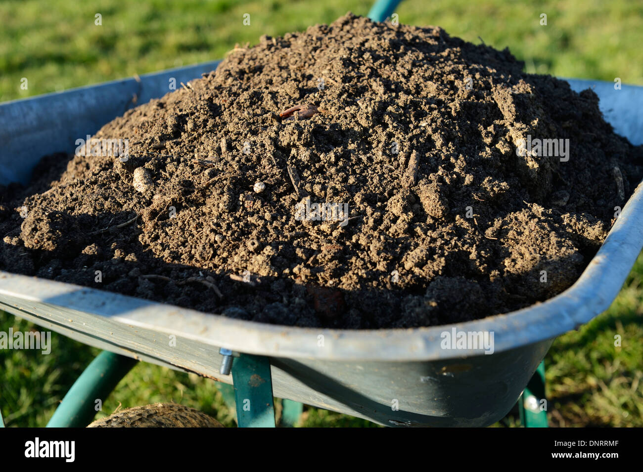 Wheelbarrow full of soil Stock Photo Alamy