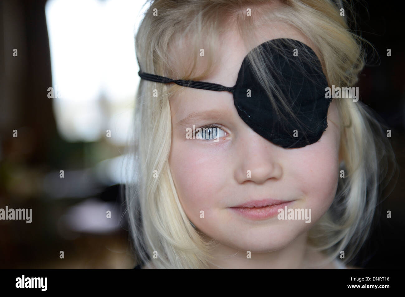 An 8 year old girl wearing a black eye patch Stock Photo