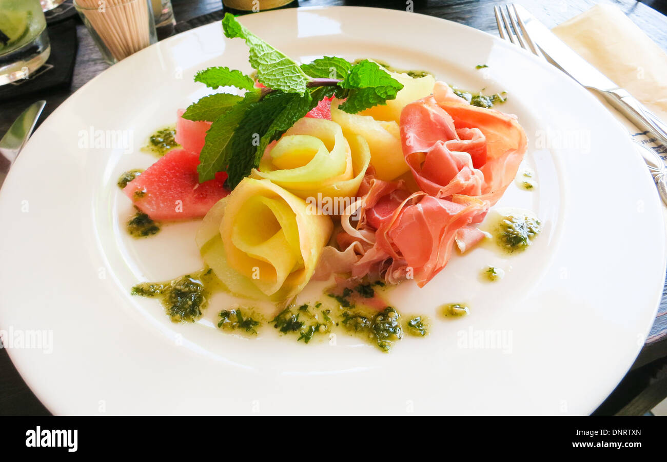 Melons and Prosciutto arrainged on a plate. Stock Photo
