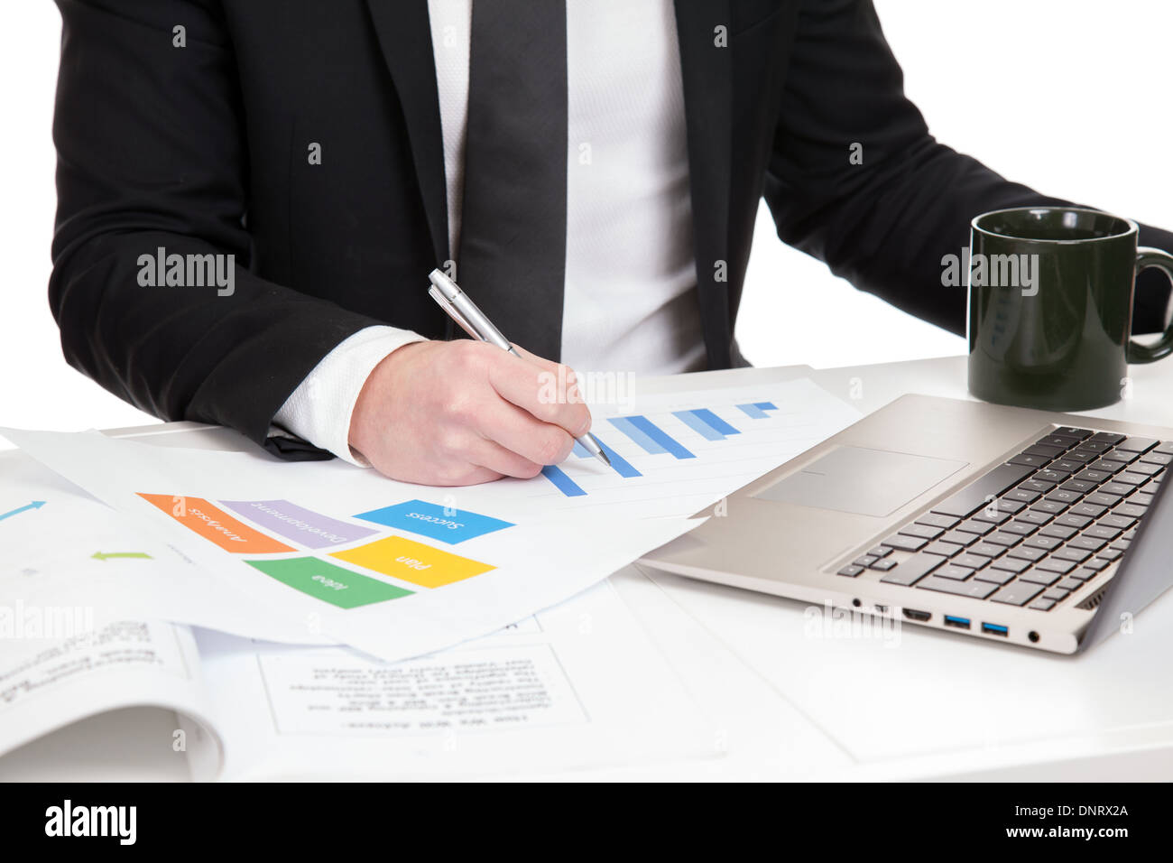 Businessman analyzing data on office desk Stock Photo