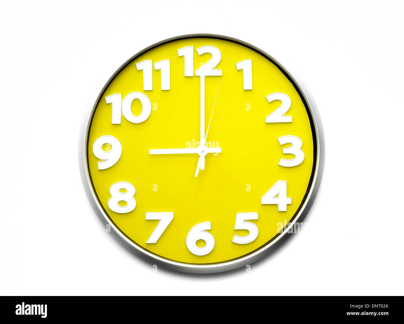 yellow clock face 9 o'clock the clock strikes nine 21.00 hours Stock Photo  - Alamy