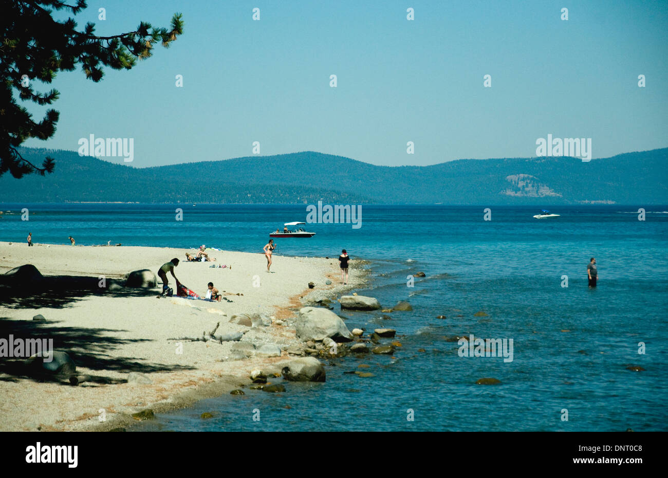 Vacationers enjoy a sandy beach at Sugar Pine Point on the western Californian shore of Lake Tahoe Stock Photo
