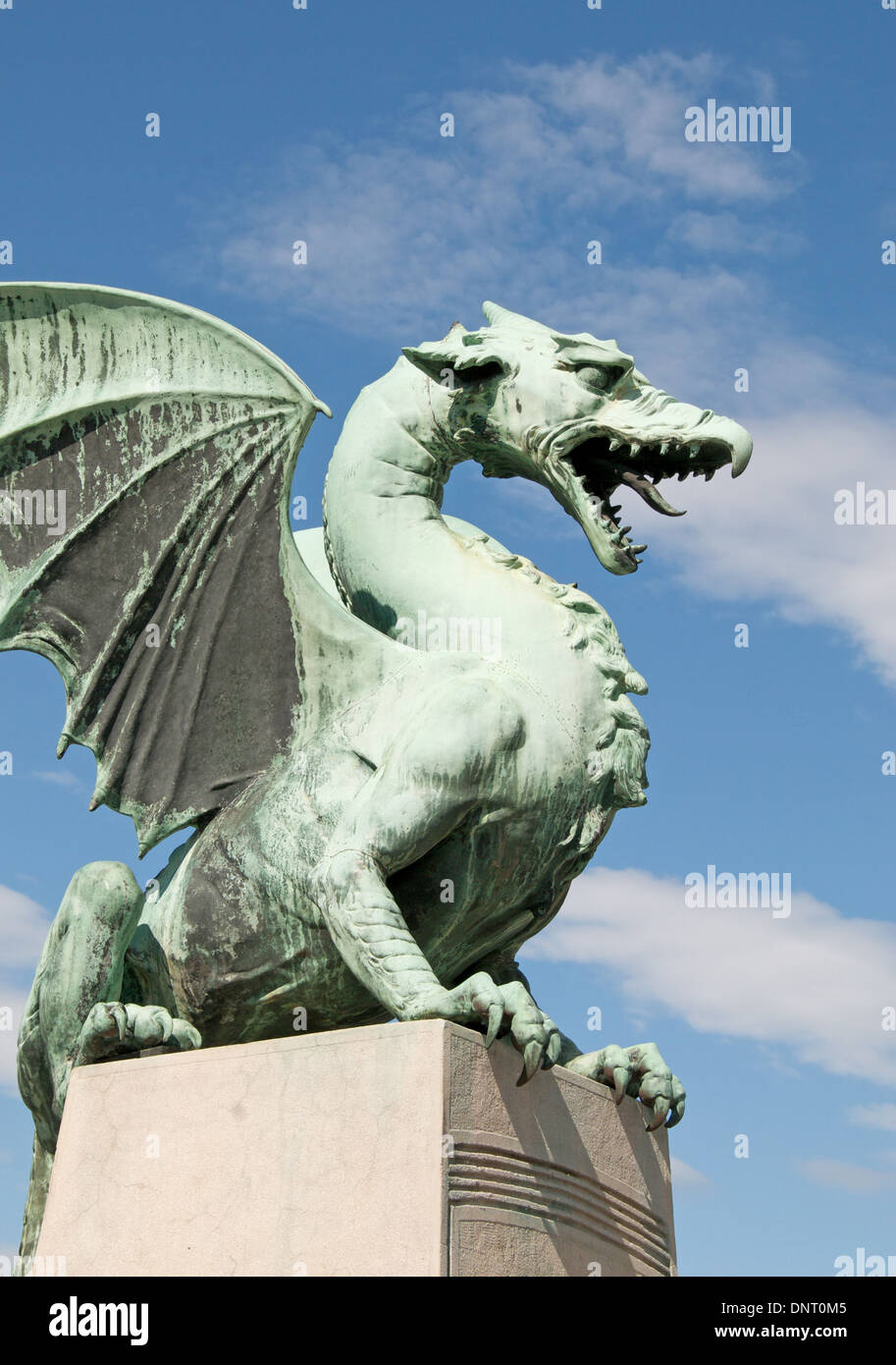 Dragon statue guarding bridge over the Ljubljanica River in Ljubljana, Slovenia Stock Photo