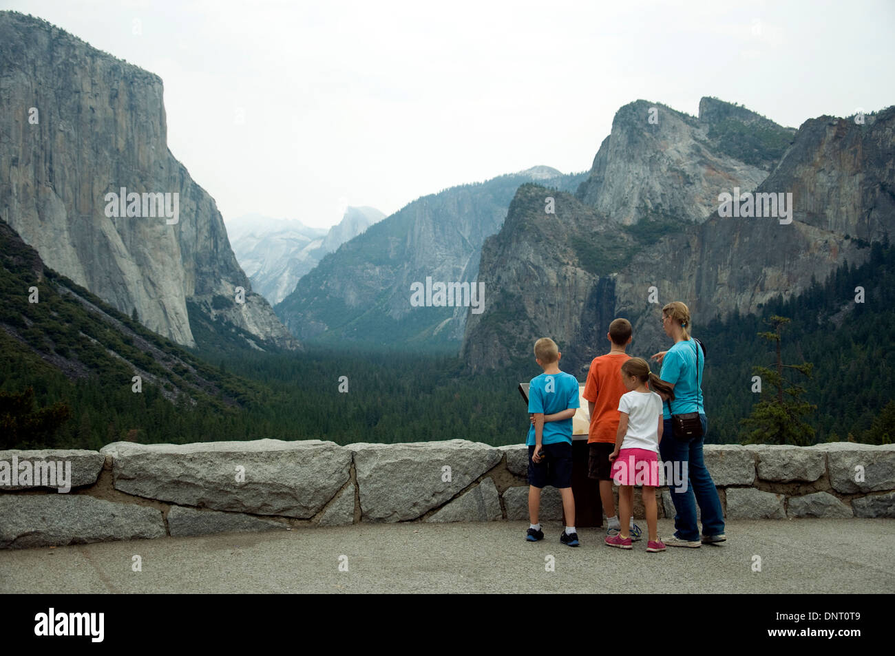 In California's Yosemite national park a tired girl seems indifferent to the grandeur of the renowned Tunnel View Stock Photo