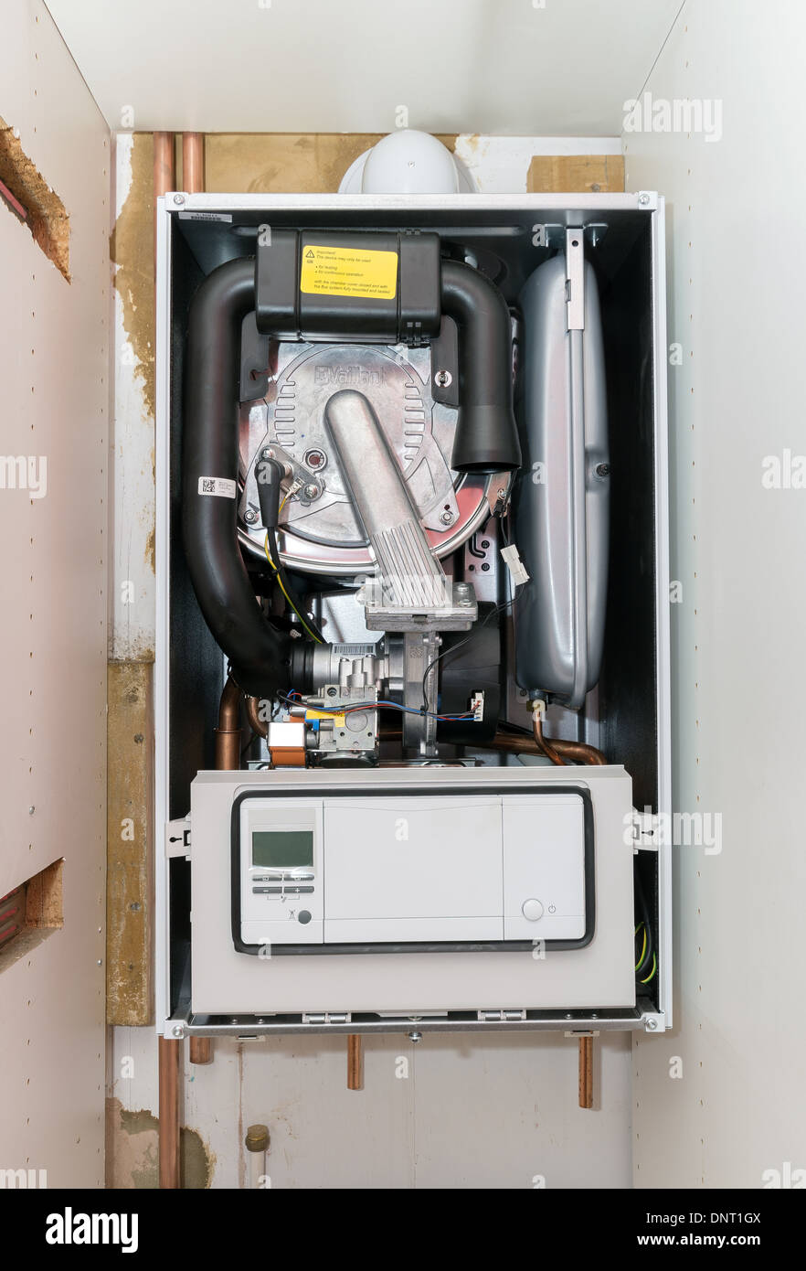 The installation of a Vaillant ecoTEC pro 28 combination boiler into  kitchen cupboard Stock Photo - Alamy