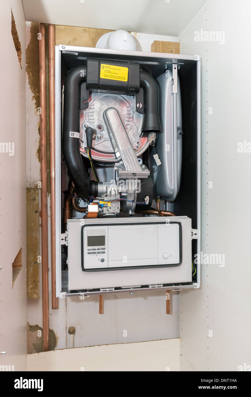 The installation of a Vaillant ecoTEC pro 28 combination boiler into  kitchen cupboard Stock Photo - Alamy