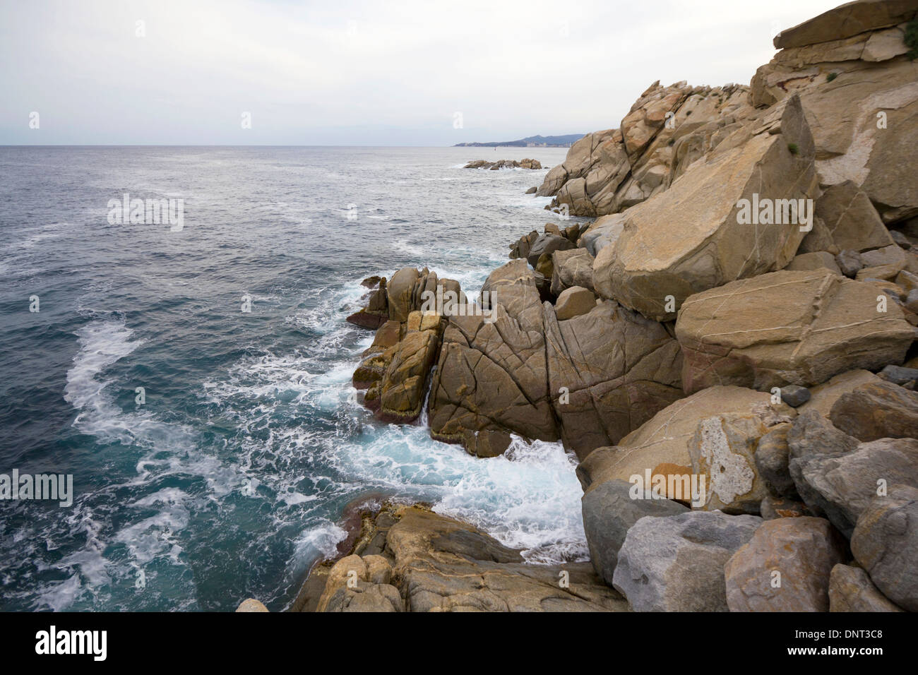waves in coastal mediterranean sea with stones in Palamós (Catalonia, Spain) Stock Photo