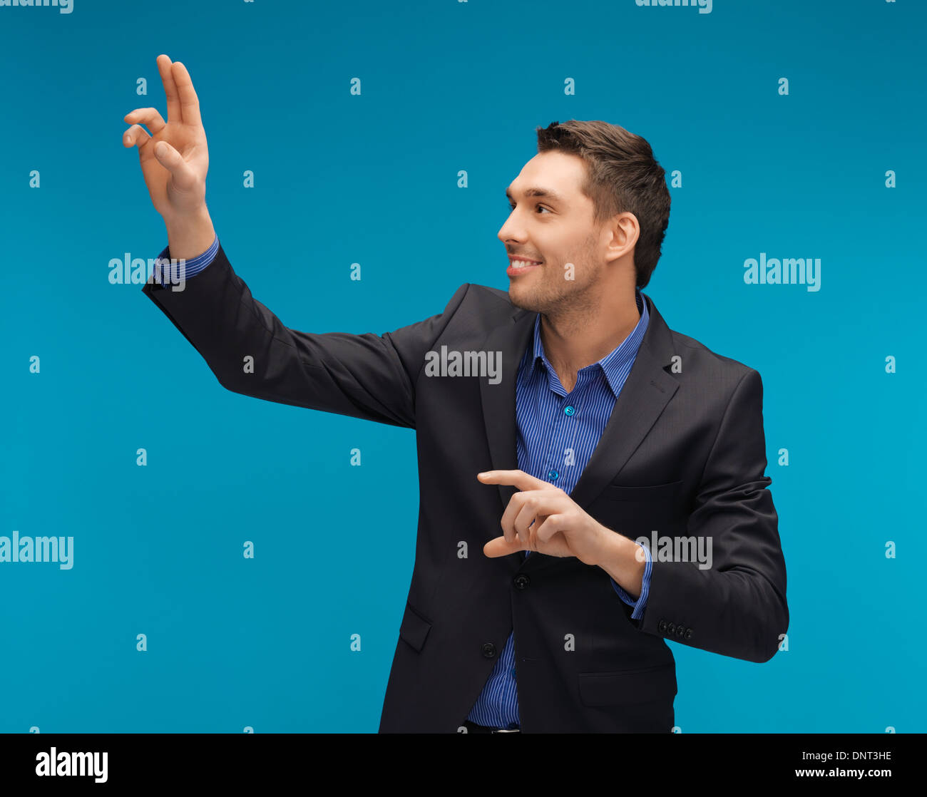 man in suit working with something imaginary Stock Photo