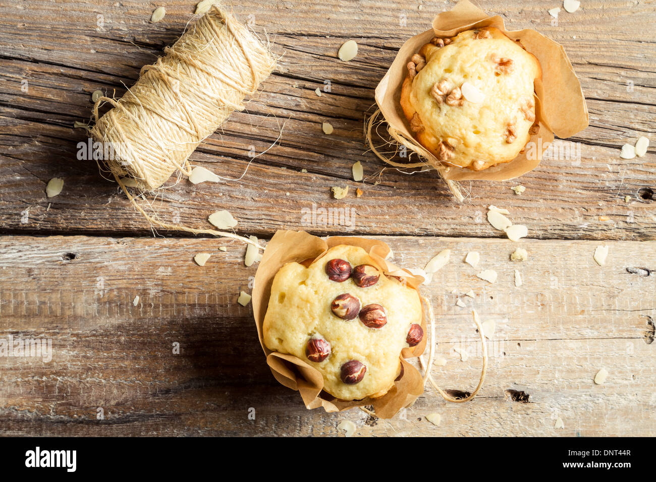 Decorating vanilla muffins with paper and string Stock Photo - Alamy