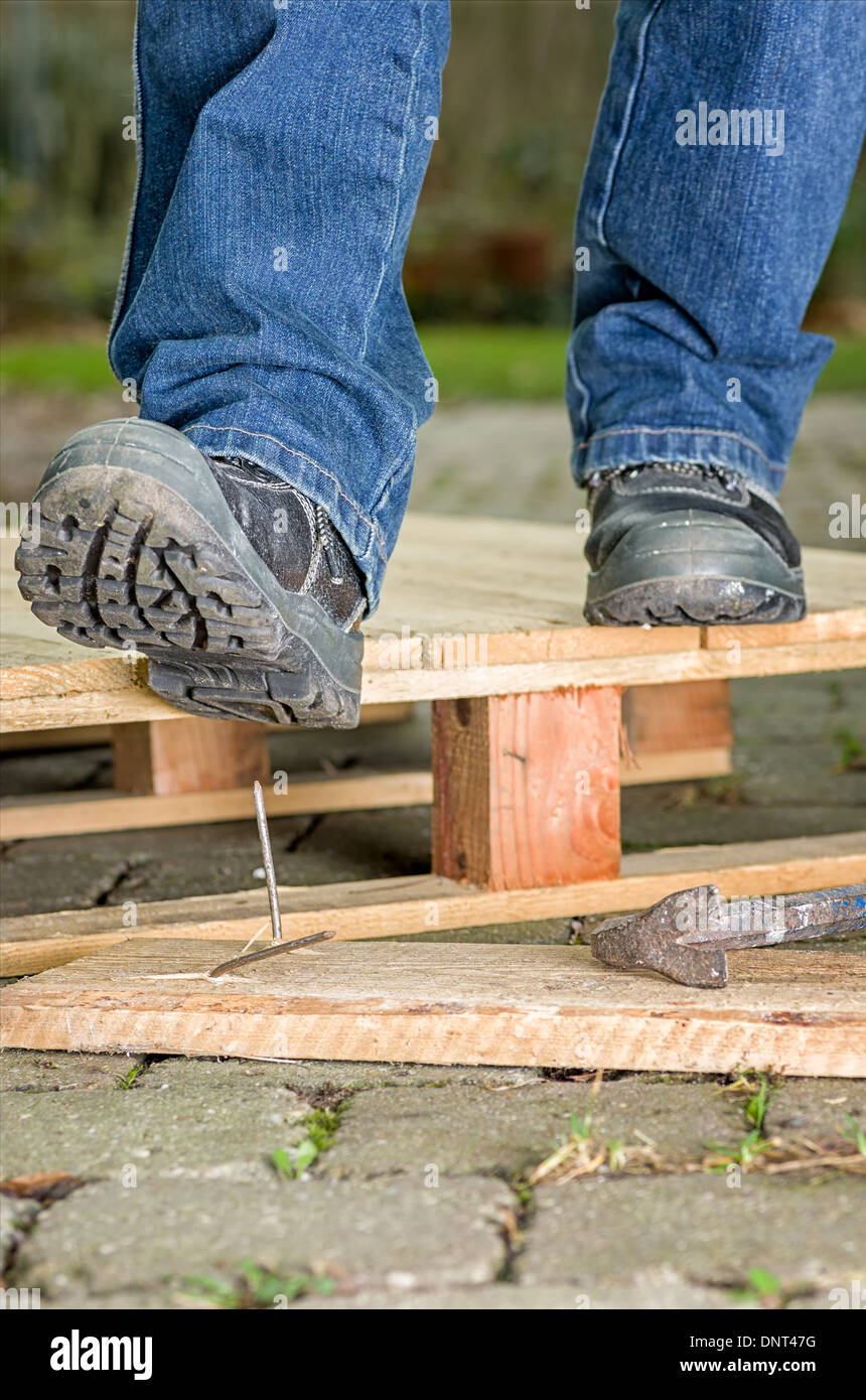 Worker with safety boots steps on a nail Stock Photo Alamy
